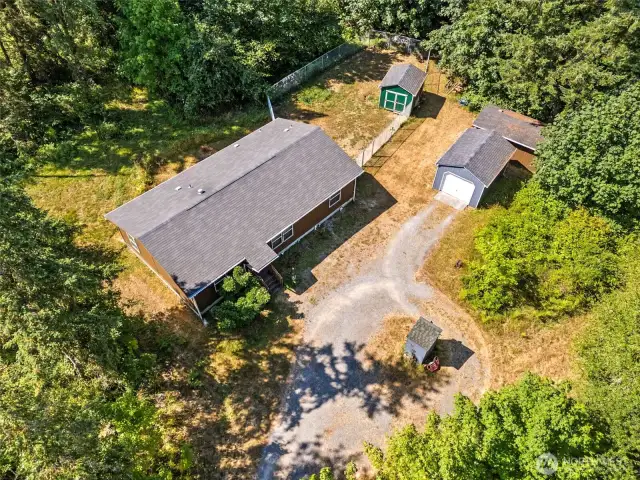 Home, shop with electricity, garage and extra storage sheds! And fully chain linked fenced back yard. Fence has 2 gates.