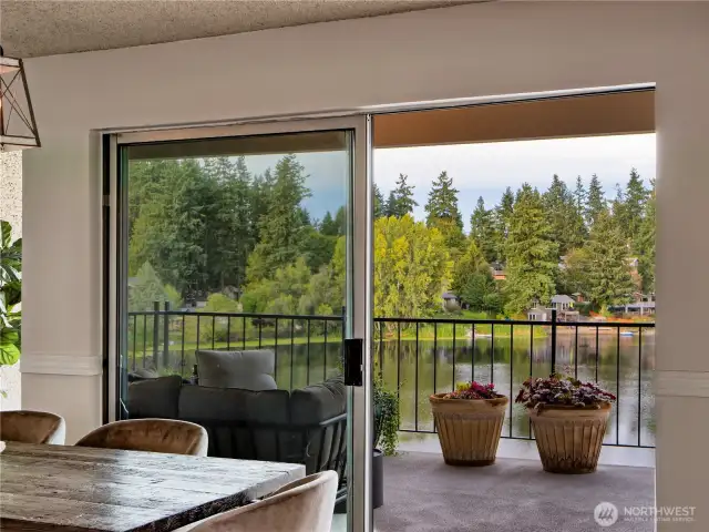 Indoor-outdoor living at its best—sliding doors open to breathtaking lake views