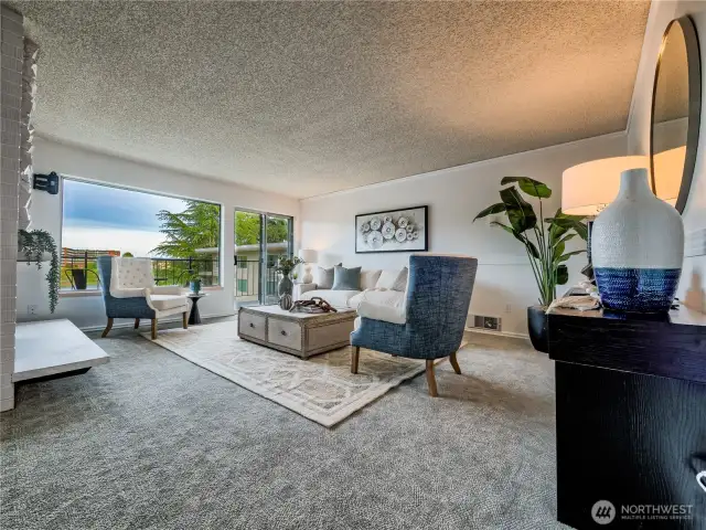 Spacious living room flooded with natural light and stunning lake views, perfect for relaxation and everyday comfort.