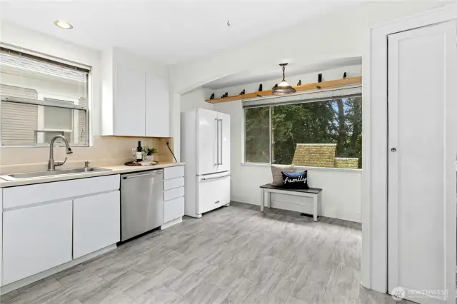 The large kitchen has new flooring, (something about dishwasher), French door fridge, and room for a small table or island. Don't miss the pantry to the right.
