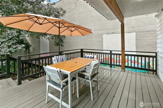 The partially covered deck has updated railing and easy-to-maintain Trex-type decking material, and is a great space to entertain. The large umbrella is included in the sale.