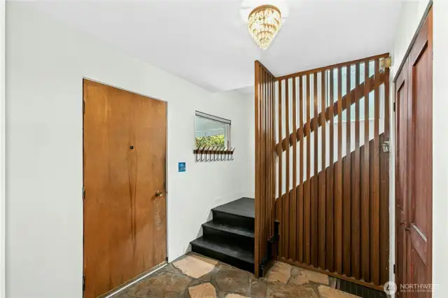 The slate entry has architecturally interesting charm and a coat closet! This home has storage!