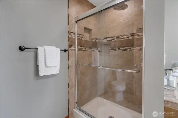 Tiled step in shower in Primary Bath.