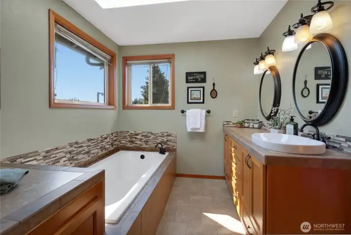 Soaking Tub and newer vanity in the Primary Bath.