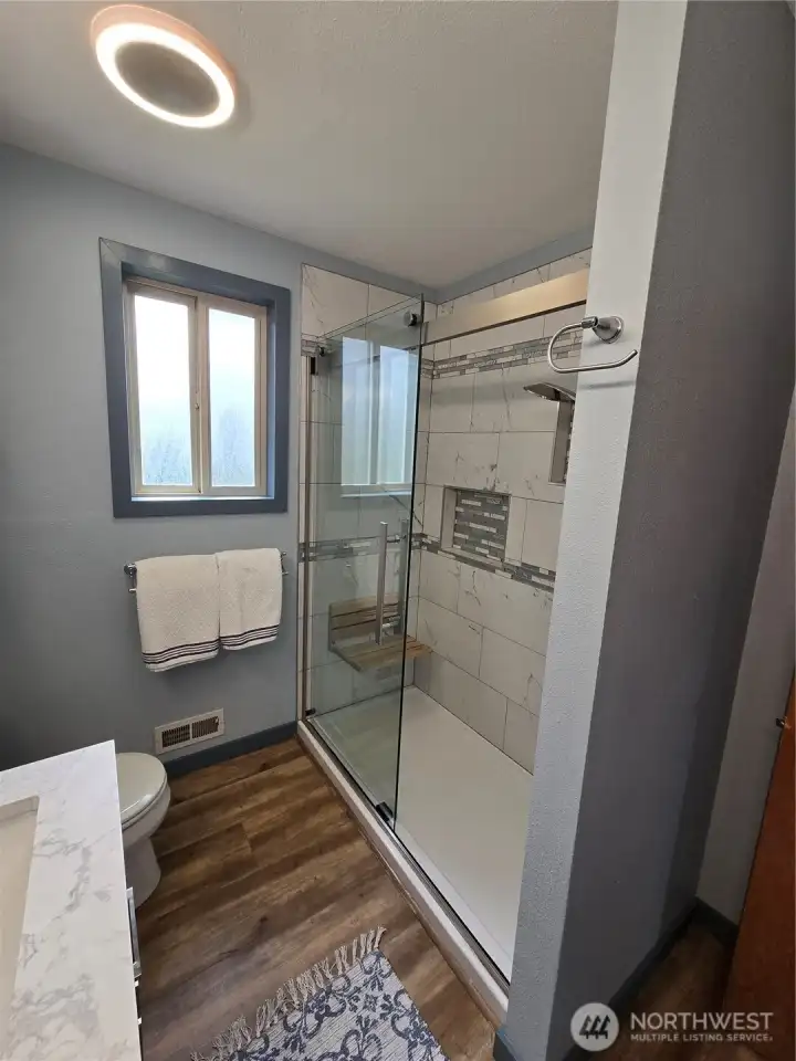 Tiled shower in Upstairs Hall Bath.