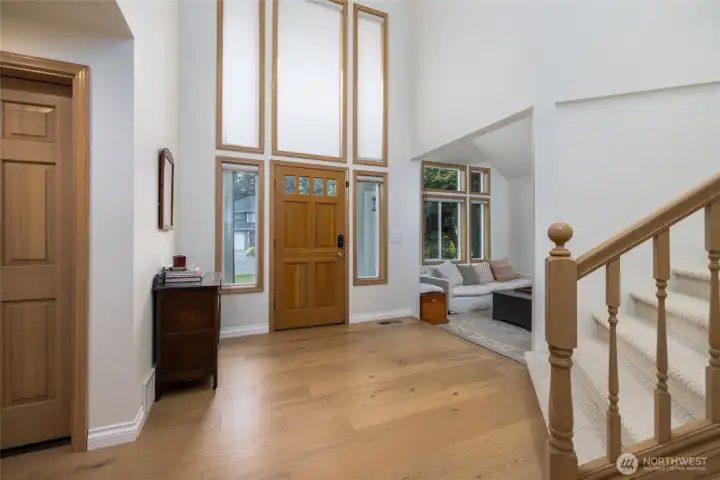 Gracious entry w/cathedral ceiling, new high-end engineered hardwood flooring and carpet. Living room to the right.