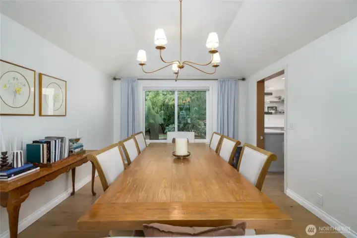 Formal dining room has new engineered hardwood floors, view to the fenced backyard.