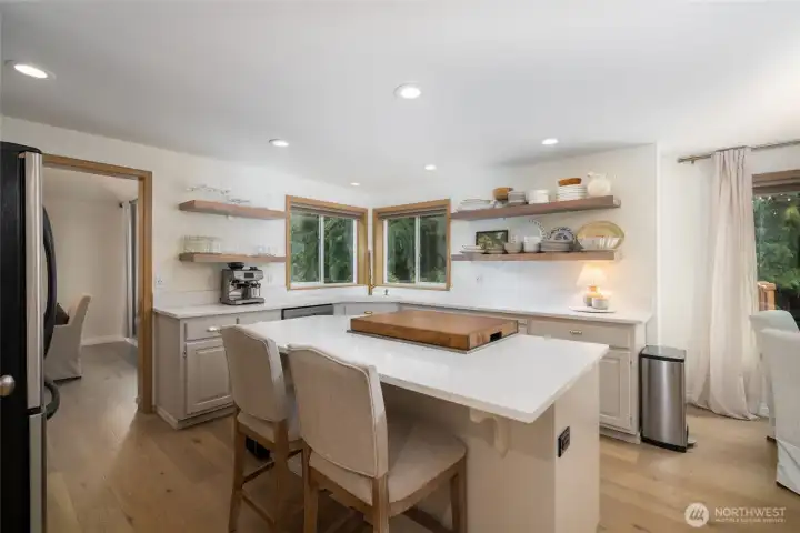 Dream kitchen has center island w/natural gas range/oven.  Light, bright, and open, with views to the back yard, stainless appliances, new quartz counters, pantry.