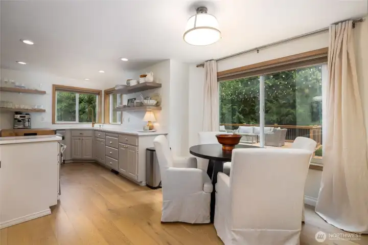 Cozy breakfast nook overlooks the spacious deck and fenced yard.