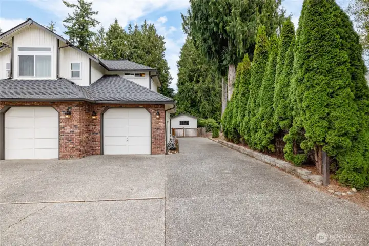 Attached 3 car garage, plus additional paved parking beside the house. Privacy hedge. Storage shed.