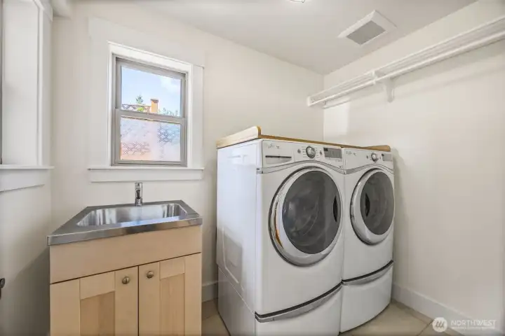 Main floor laundry room with plenty of space to wash, hang, and fold.