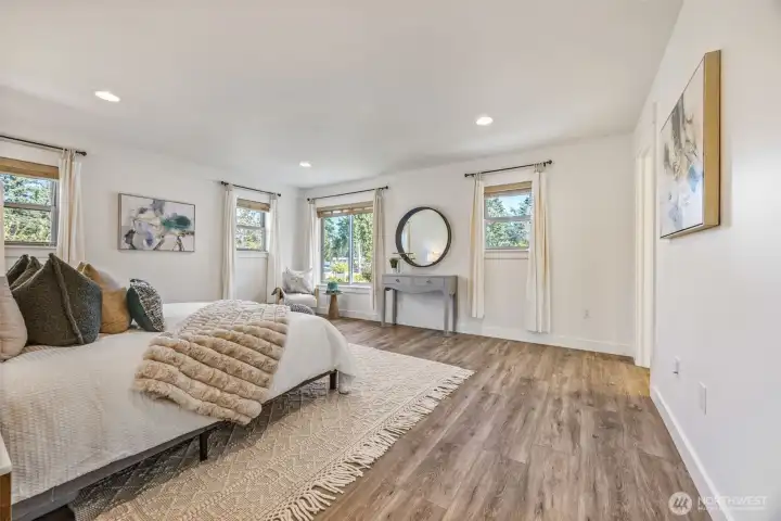 The primary bedroom is bright and spacious with a full attached bathroom and walk-in closet.