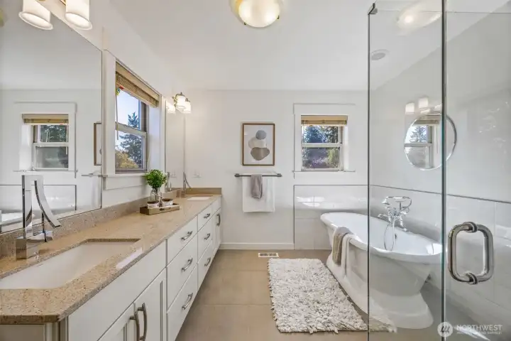 Full primary bathroom with double vanity and stand alone bathtub.