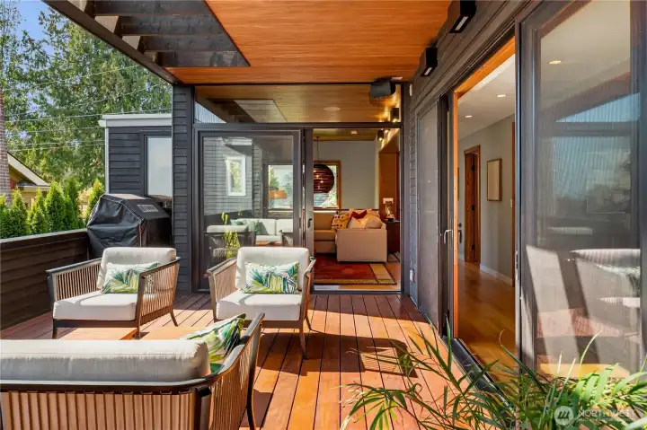 An inviting covered deck extends the living space outdoors — perfect for year-round entertaining.