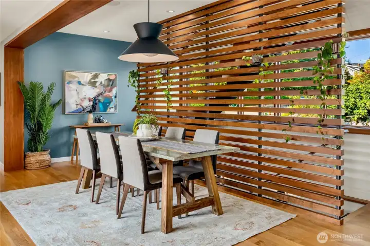 A striking wood-slat architectural screen adds warmth and style to the dining room’s clean modern lines.