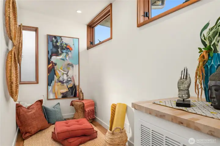 A serene flex nook offers the perfect spot for yoga, reading, a peloton workout or quiet retreat.