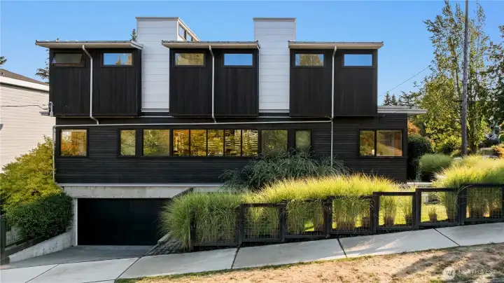 The rare 2-car attached garage anchors the modern design while ensuring everyday convenience.