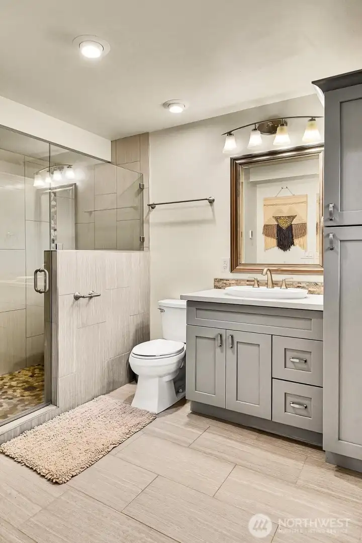 Don’t miss the stunning ¾ bath down here—heated tile floors, walk-in shower, modern lighting, and great storage!