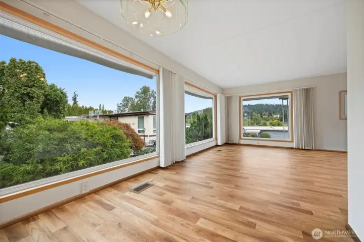 Dining and living space with huge portrait windows.