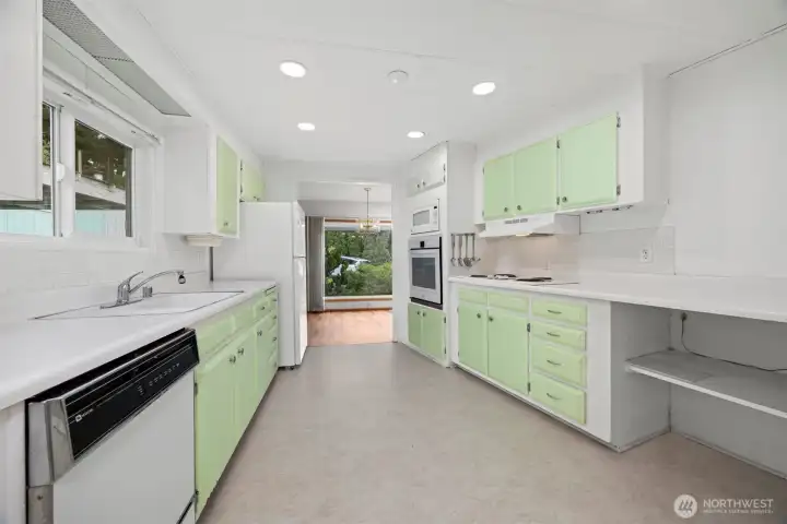 Bright kitchen with tons of counter space and cabinets.
