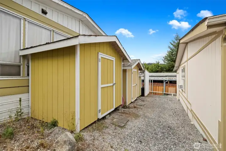 Multiple storage sheds included.