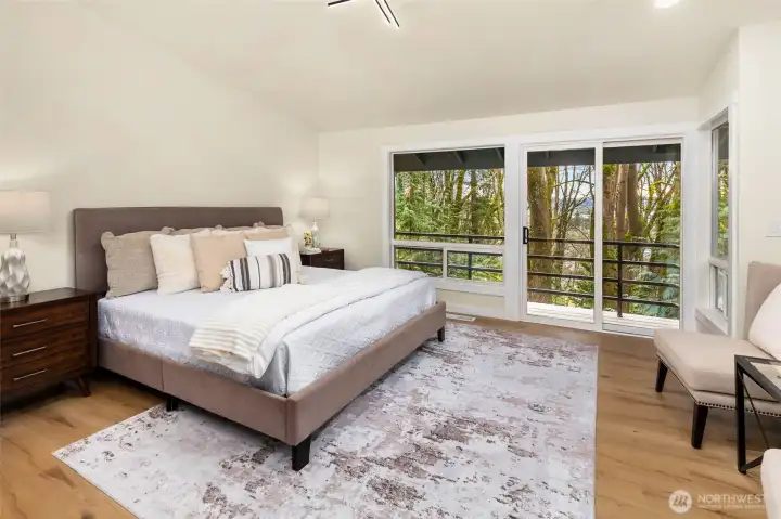 Main level, spacious primary nestled among the trees.