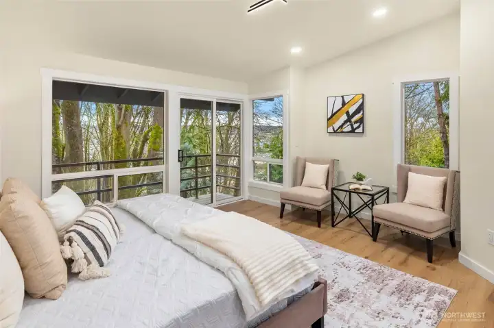 Sliding door leads to the first of two balconies in the primary bedroom