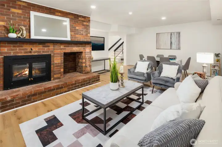 The lower level offers a generous living space with wood-burning fireplace, 3 bedrooms, full hall bath and utility room