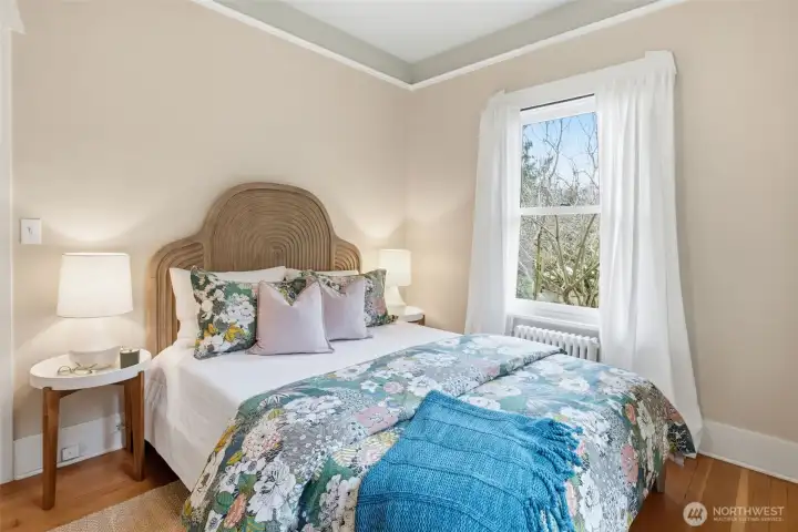 The main floor bedroom looks out to the garden area. The closet has access to the attic with expansion potential.