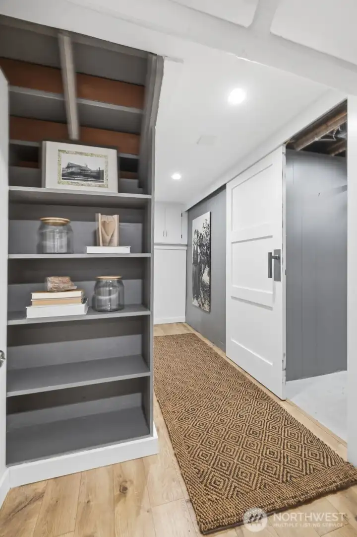 The finished lower level with a separate entrance offers flexibility or potential rental use, plus excellent storage & a large capacity wine cellar perfect for aging your collection. The sliding barn door on the right leads to the boiler room with extra storage space and a separate room with a wine cellar.  A consistent cool temperature all year round is the perfect environment to store your wine collection.