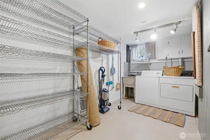 Laundry utility room with utility sink & stainless steel racks for extra storage.