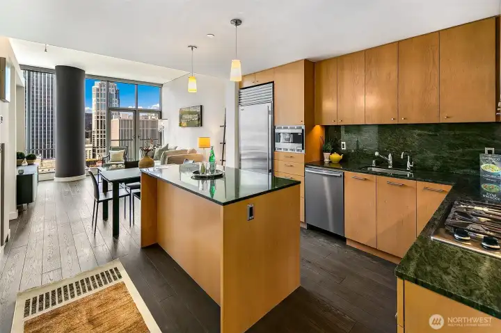 Open living layout with huge kitchen and hardwood floors.