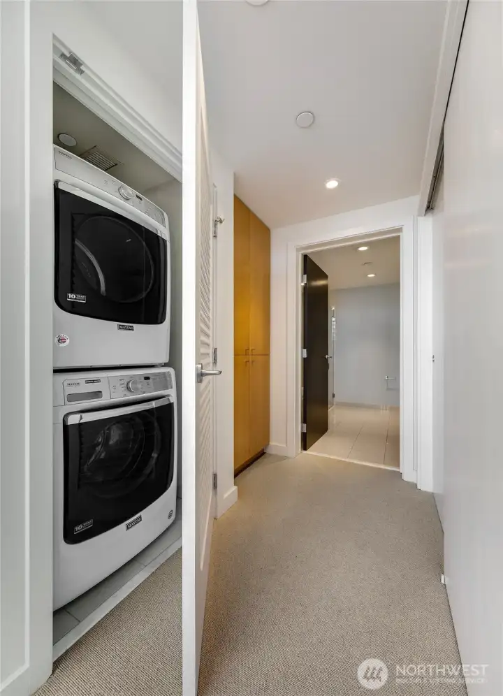 Full size washer and dryer and closets on both sides leading to ensuite bath.