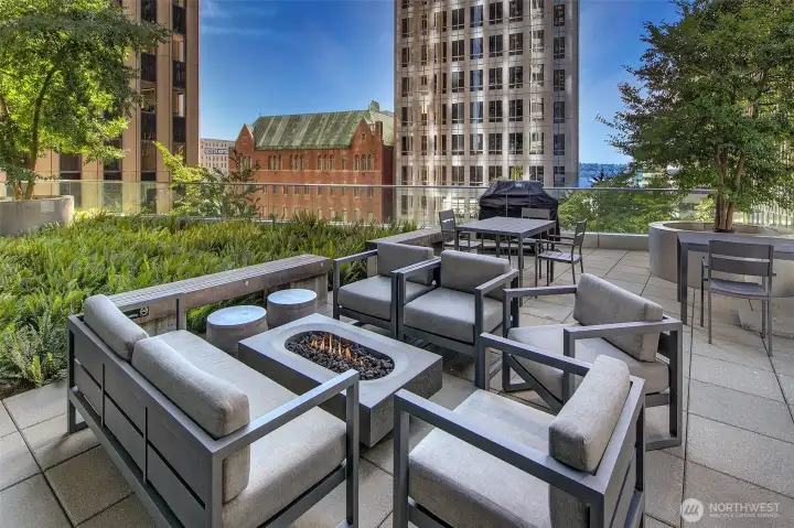 Spacious outdoor deck with fire pit and barbecue.