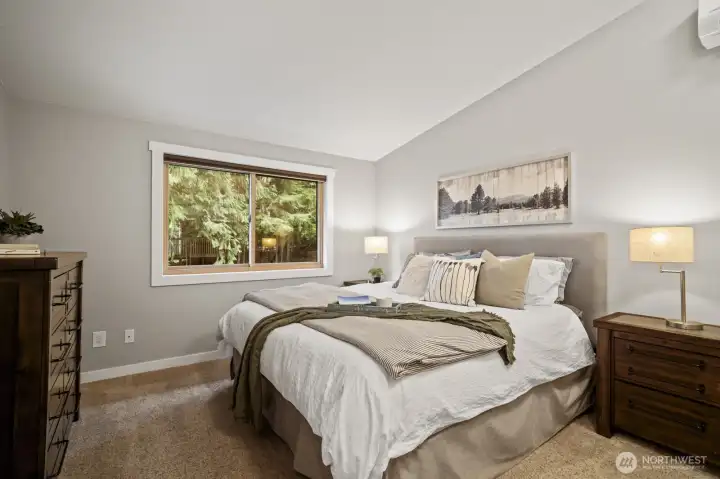 Spacious primary bedroom featuring vaulted ceilings and mini-split A/C.