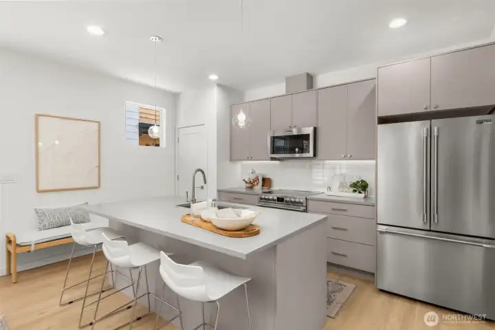 The open-concept layout creates a fluid connection between the kitchen and living spaces, ideal for entertaining.