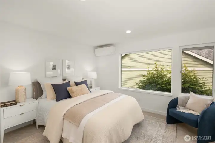 The secondary bedroom offers a quiet retreat with a plush, cozy feel and ample closet storage.