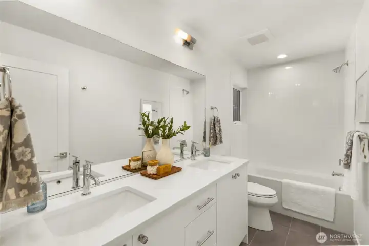 The primary bedroom is an oasis of calm, featuring soft lighting and a spacious, airy layout.