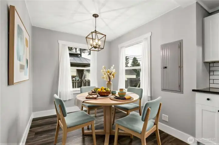 Virtually Staged eating nook looking over side yard playground and back yard deck with pergola