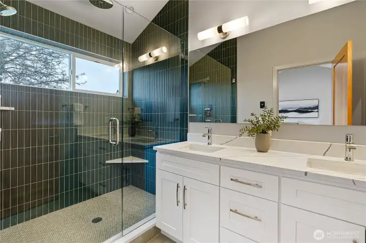 Beautiful ensuite bath with custom tile and a double vanity.