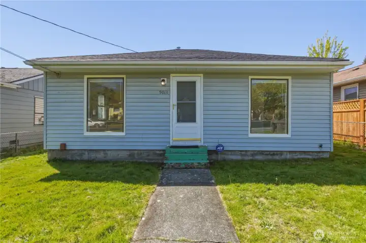 Front of home with fenced yard.