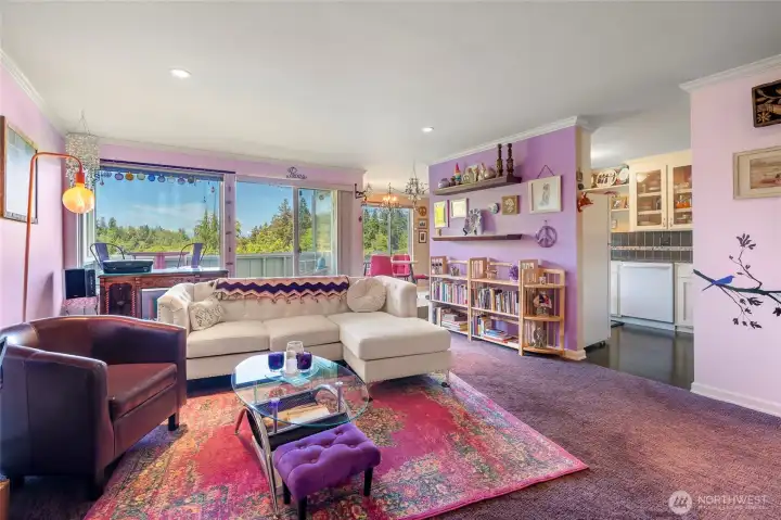 Spacious living room flows seamlessly to private deck & dining area