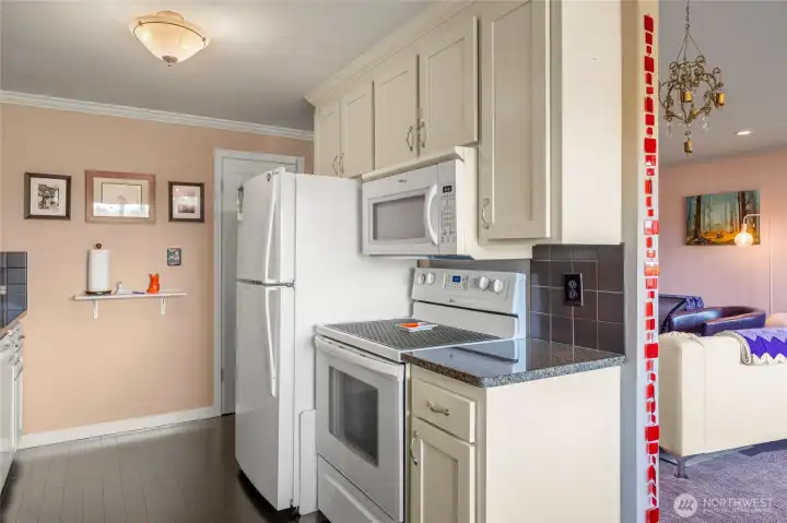 This kitchen features a ceramic cooktop & a ton of storage space.