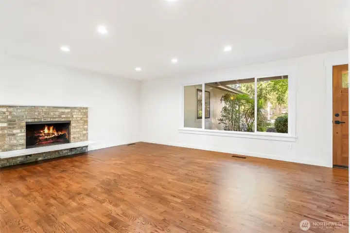 Wood burning fireplace with sitting hearth. Refinished hardwood floors throughout. Wood burning fireplace with sitting hearth. Refinished hardwood floors throughout.