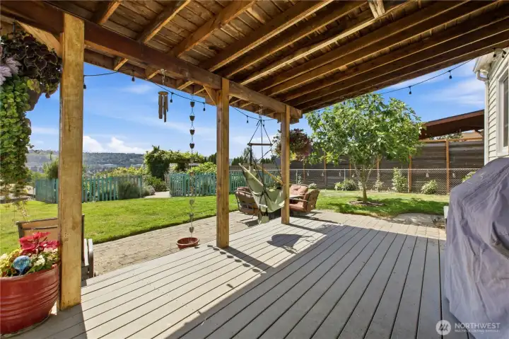 Covered back deck with extra patio surround.