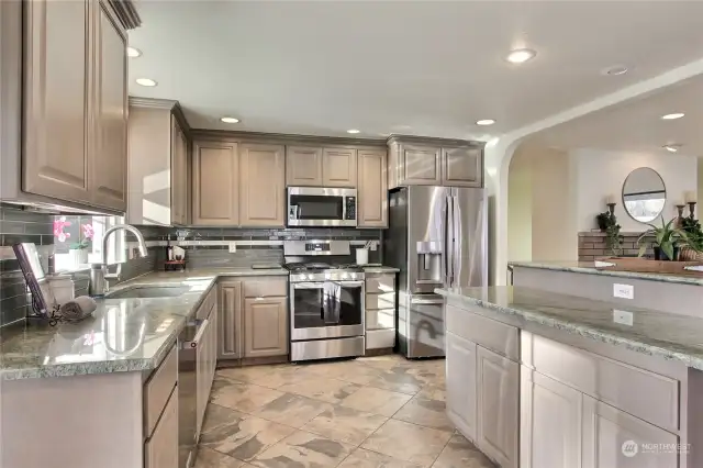 Gorgeous granite countertops, stainless appliances and tons of storage make this kitchen functional and beautiful.