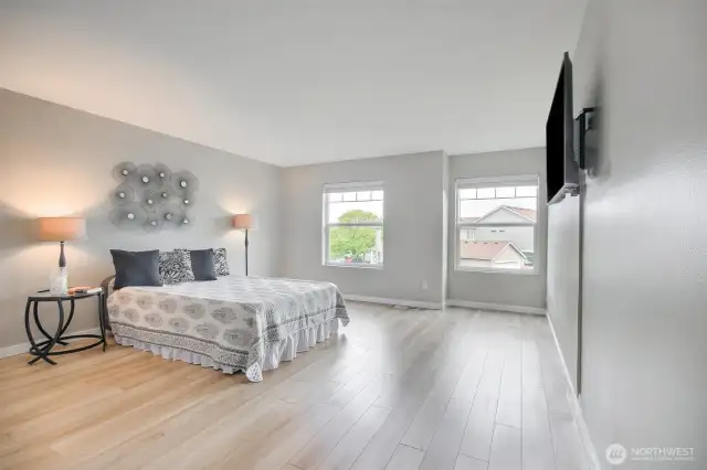 Huge primary bedroom is large enough for all your furniture plus a sitting room