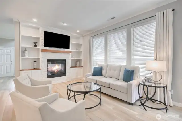 Great family room with gas fireplace & built-in bookcases. Luxury vinyl plank flooring through out the house