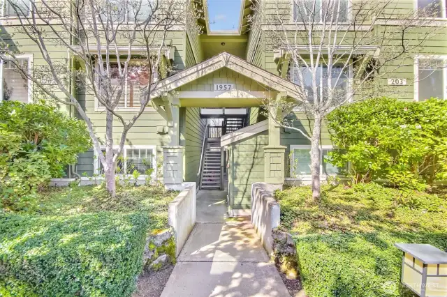 Building entry. Breeze way open staircase to the unit 203