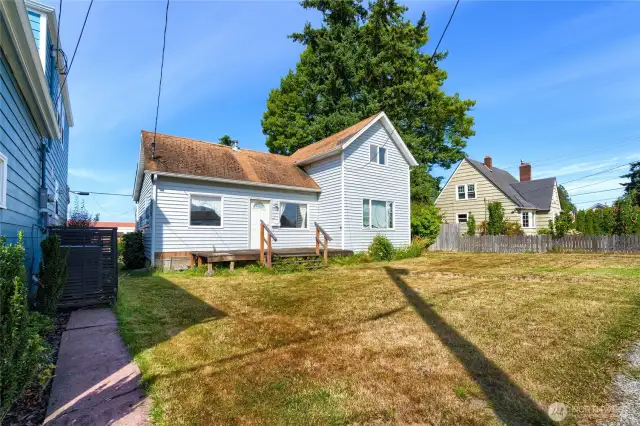 Large level front yard and deck off front entrance.